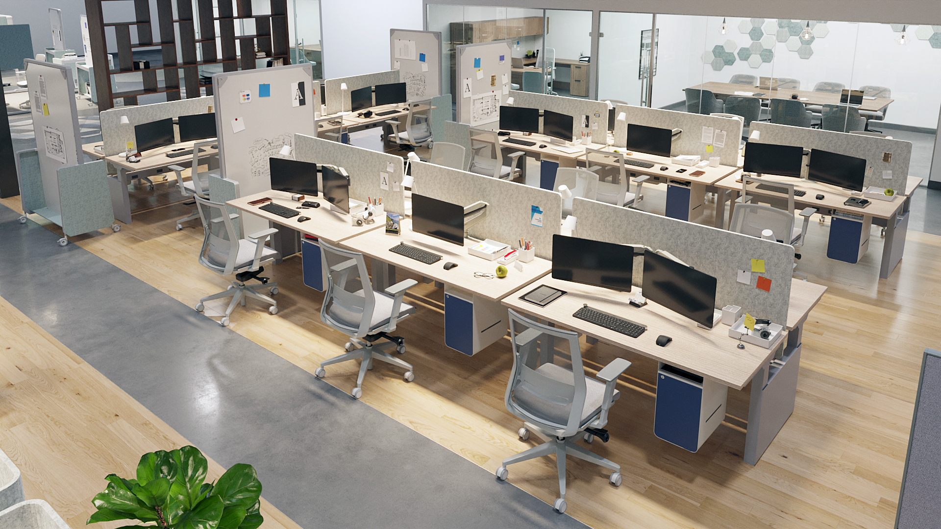 Open-plan office with modular desks, ergonomic chairs, and multiple computer workstations; glass-walled meeting area in the background.