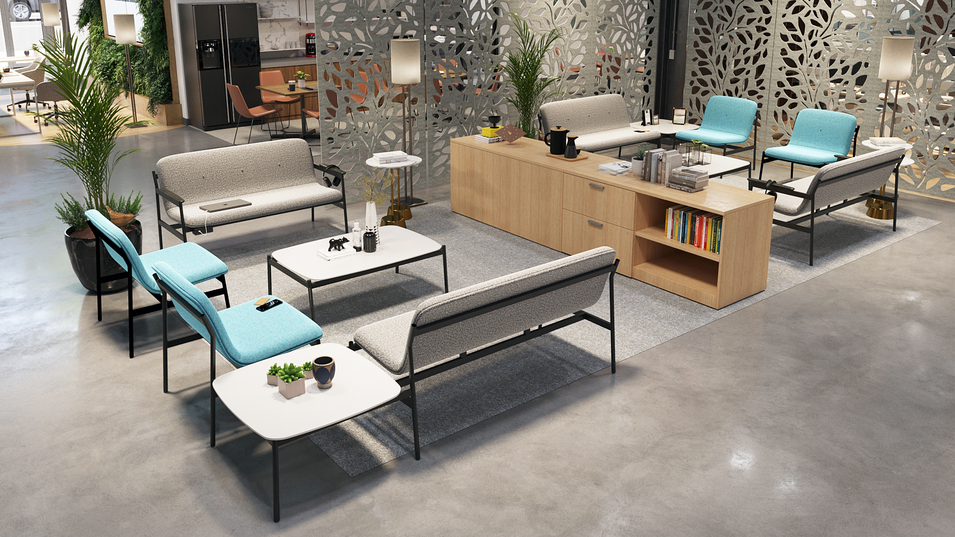 Showroom lounge with modular gray upholstered sofas, teal cushions, white coffee tables, wooden storage console, and decorative metal room dividers.