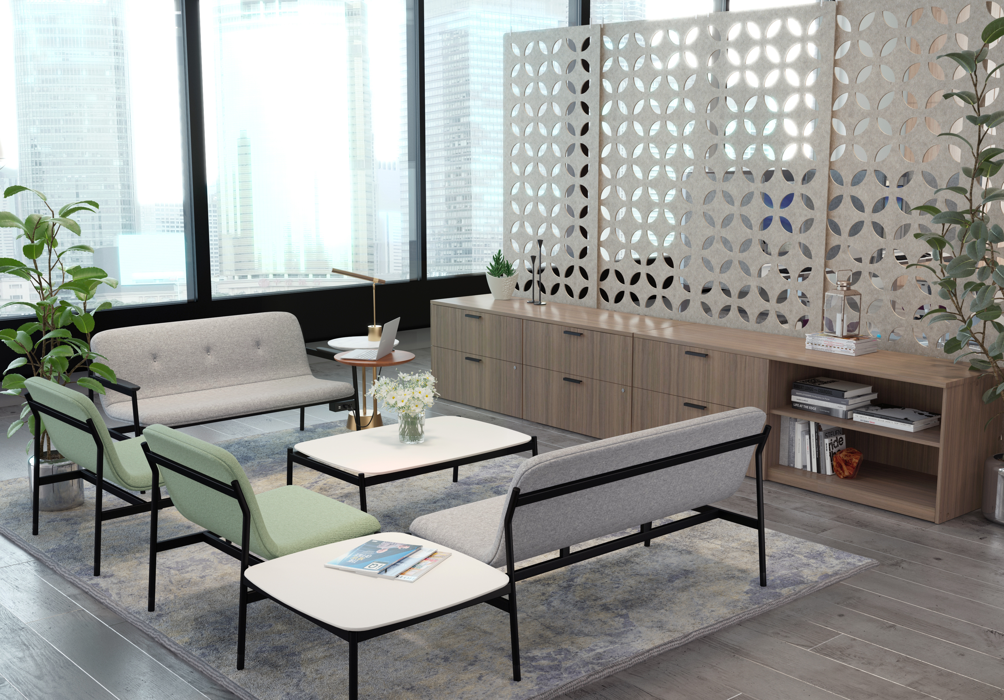 Contemporary office lounge with modular gray sofa, lime-green chairs, white coffee tables, and a long wood credenza behind a perforated screen.