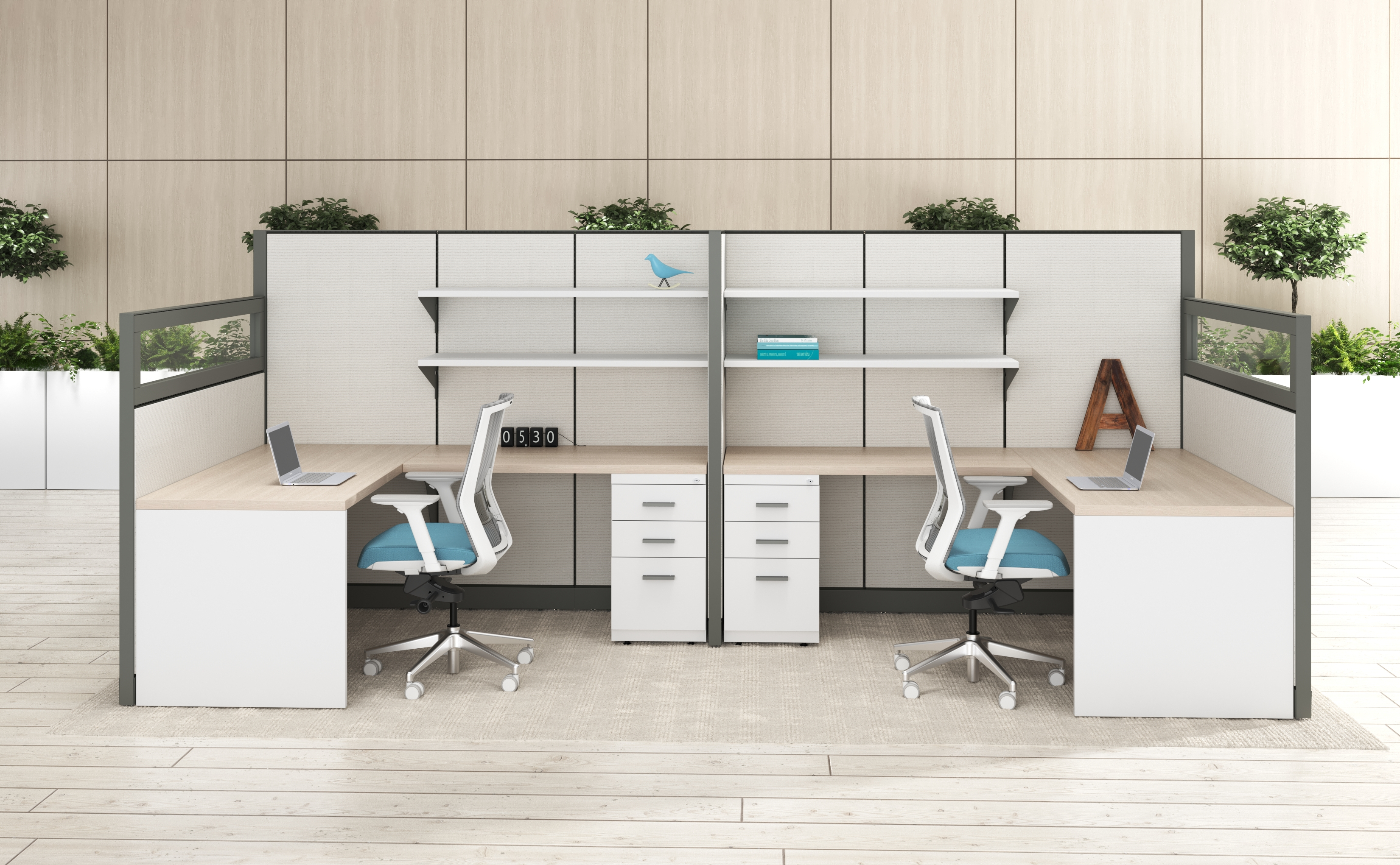 Two-person office cubicle with light wood desktops, white pedestals, gray dividers, and teal Adjustable Office Chairs in a modern showroom.