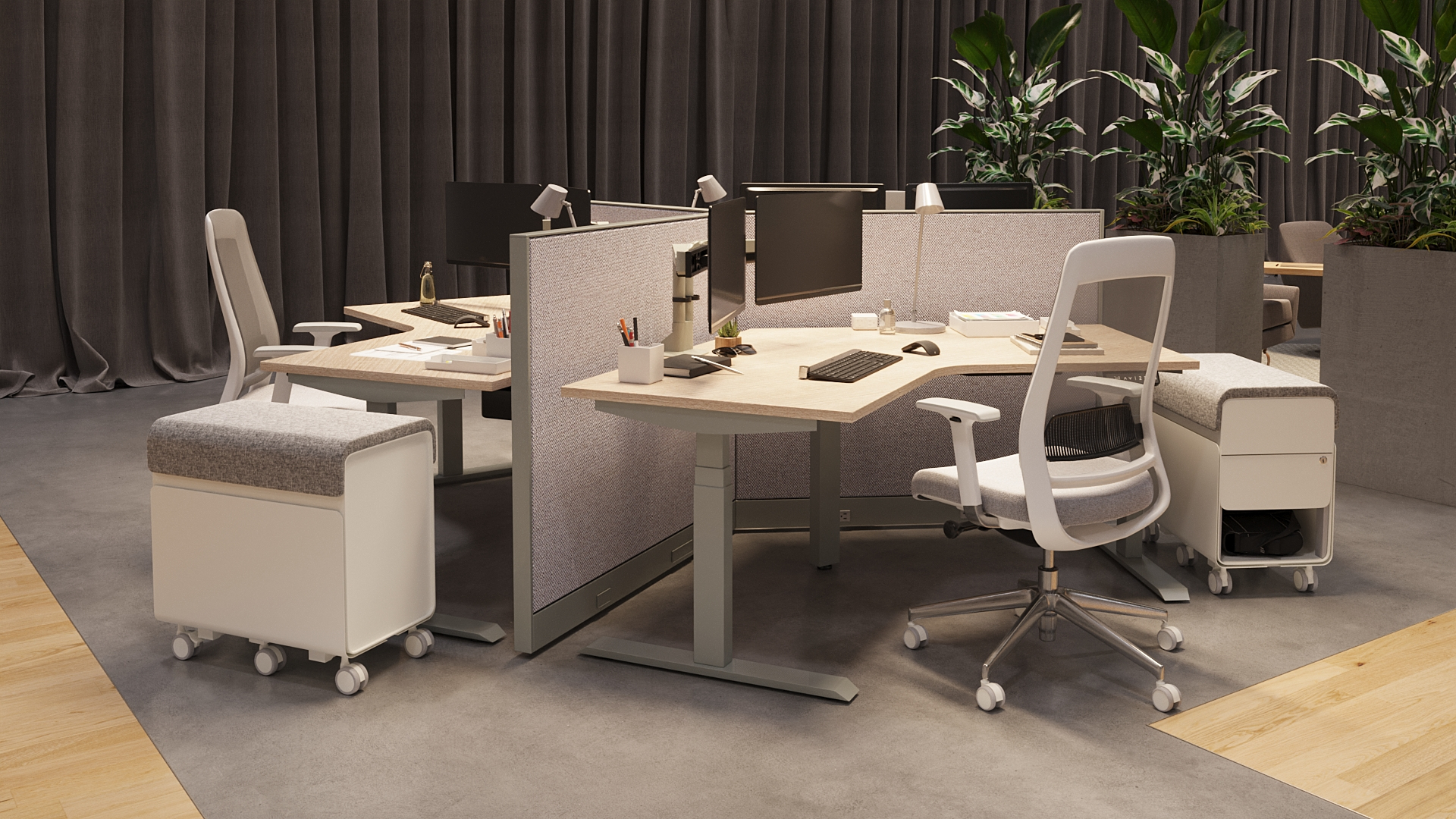 Modular workstation with L-shaped desks, white ergonomic task chair, fabric divider panels, monitors, and mobile storage pedestals.