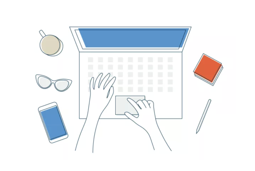 Overhead view of two hands typing on a laptop keyboard, with mug, sunglasses, smartphone, notebook, and pen on a clean desk.
